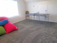 Playroom area on second level of this modular cape home provides lots of open space.